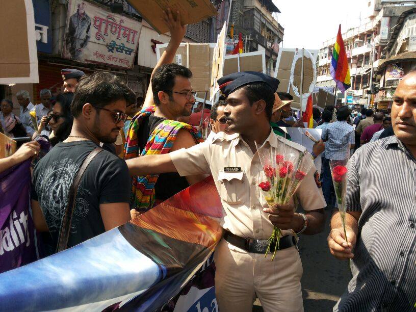 A Police personnel distributing roses in Pune Pride