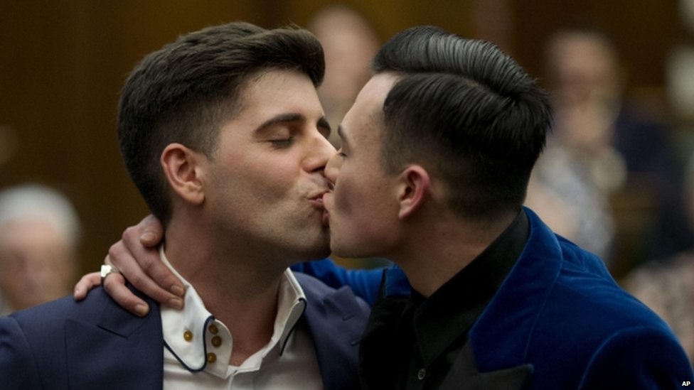 A gay couple kiss after getting married. (Picture courtesy BBC News)