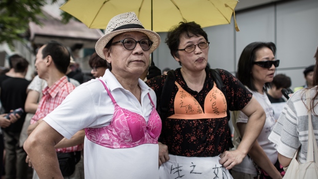 Protesters wear bras during a demonstration outside the police headquarters in Hong Kong on Aug 2, 2015. (Photo: AFP/Philippe Lopez)