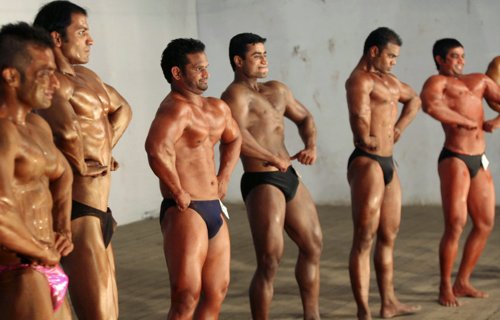 Competitors flex their muscles during the "Mr. Senior Gujarat 2010" bodybuilding contest in the western Indian city of Ahmedabad January 31, 2010. More than 200 body builders across the state on Sunday participated in a contest organised by the Gujarat state body building association in an aim to encourage youth in body building sports and to aware common people about their health, a media release said. Picture taken January 31, 2010. REUTERS/Amit Dave (INDIA - Tags: SOCIETY) - RTR29Q0D