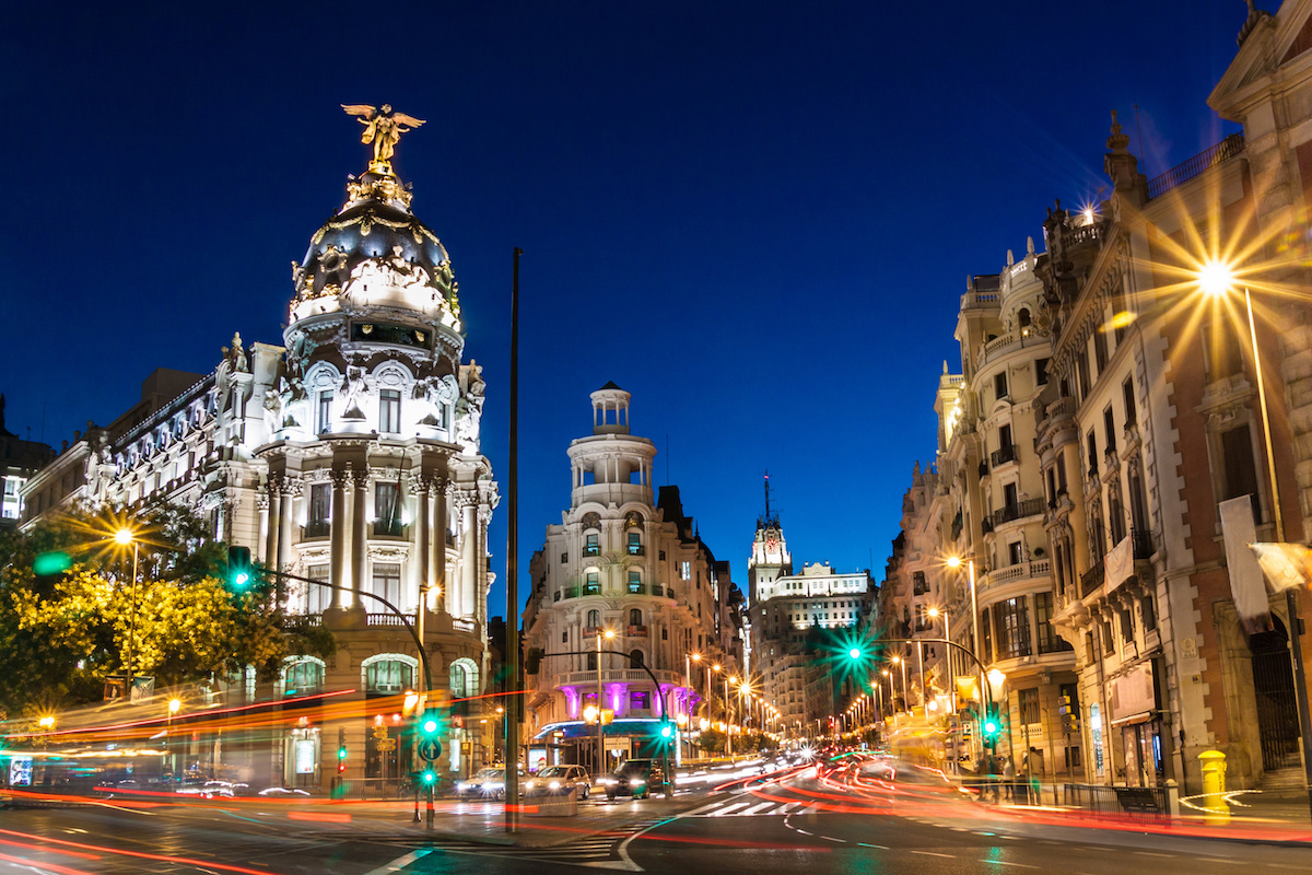 Rays of traffic lights on Gran via street, main shopping street in Madrid at night. Spain, Europe.