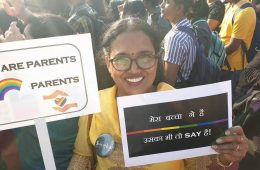 woman holding pride poster