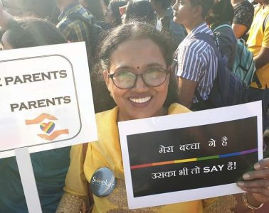 woman holding pride poster