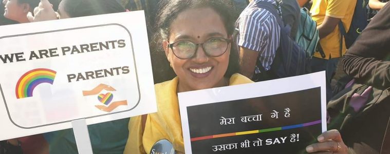 woman holding pride poster