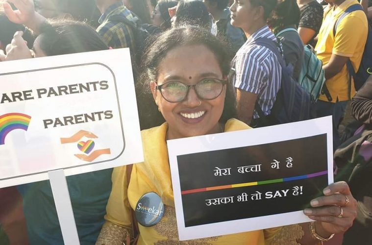 woman holding pride poster